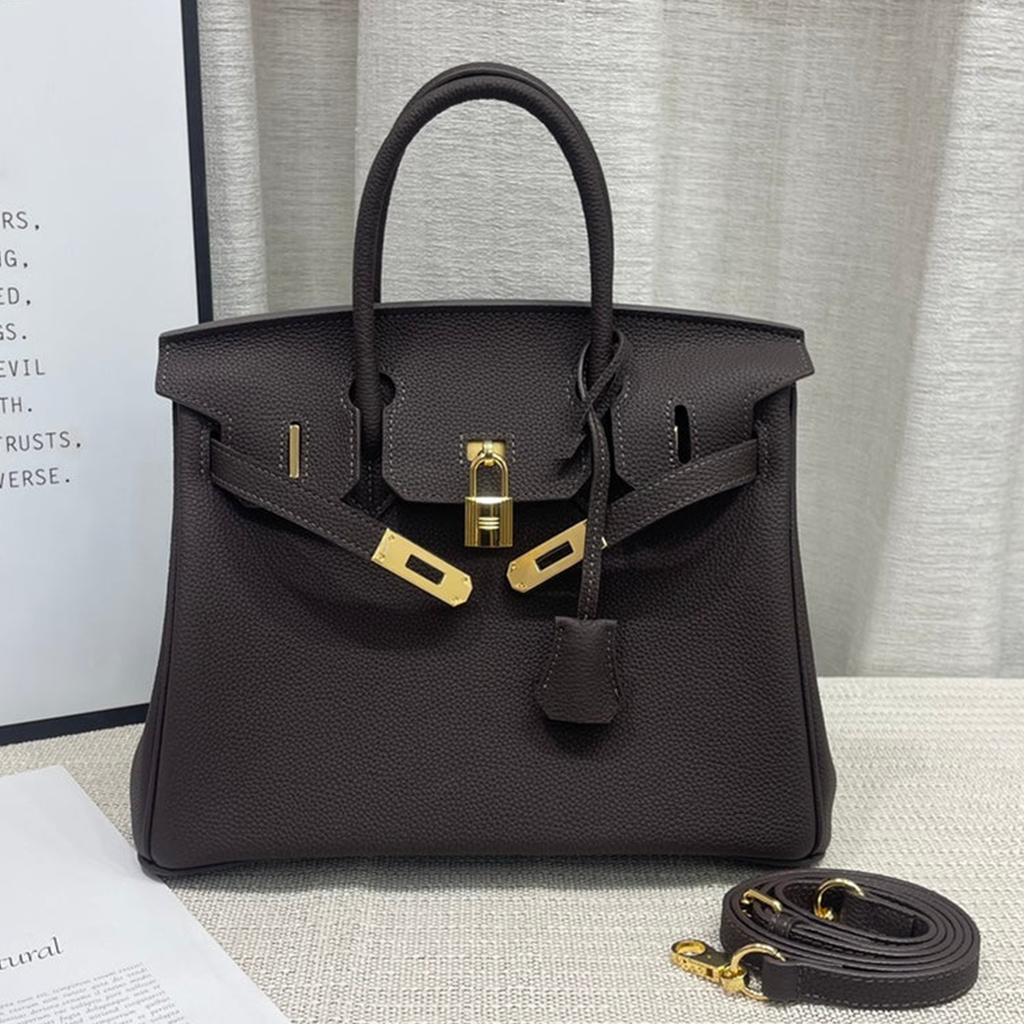 Rich Dark Mocha Brown Pebble Grain Compact Structured Trapezoid Tote With Radiant Warm Golden Twist Lock Hardware And Decorative Suspended Metal Padlock Charm