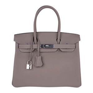 Sophisticated Muted Greige Pebble Grain Medium Structured Trapezoid Tote With Sleek Silvery Twist Lock Hardware And Hanging Decorative Metal Padlock Charm