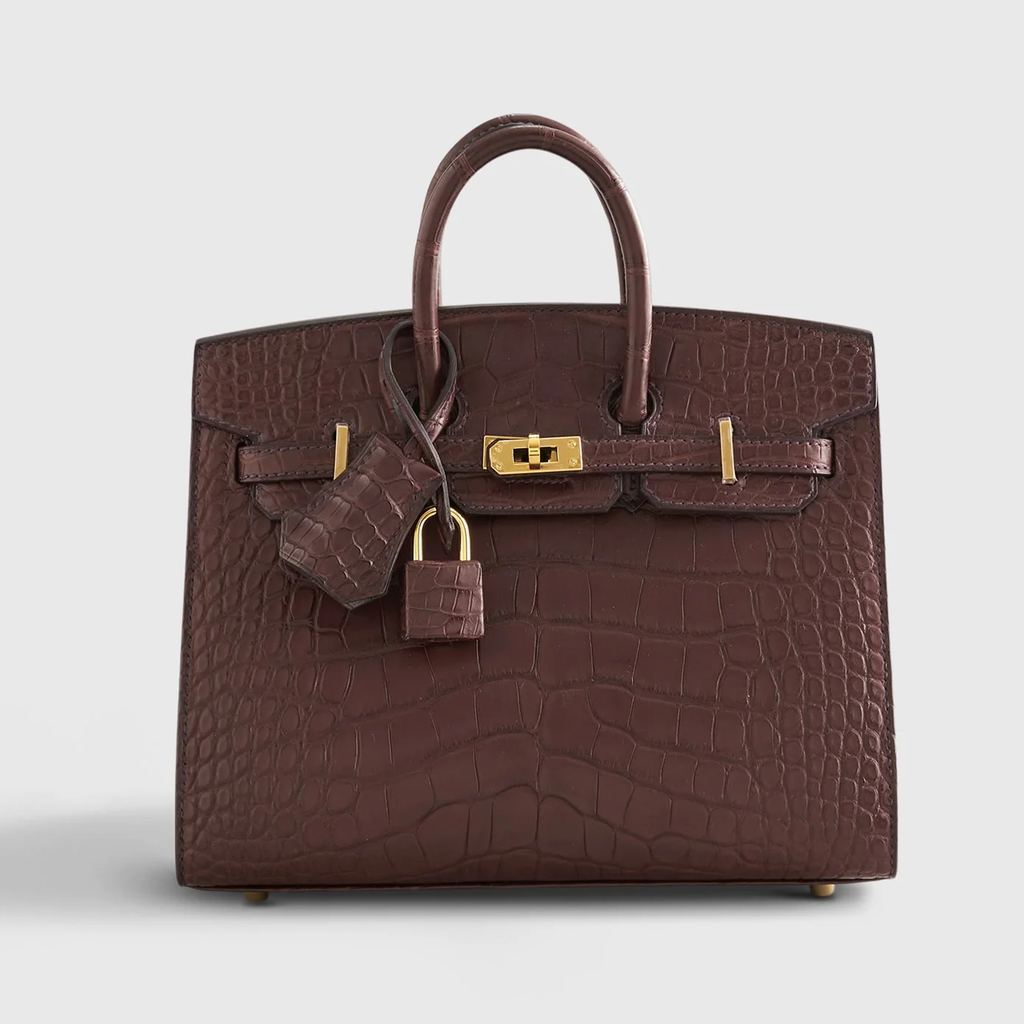 Rich Matte Hazelnut Brown Segmented Scaled Compact Sharp Edged Trapezoid Tote With Polished Warm Golden Twist Lock Hardware And Suspended Textured Metal Padlock Charm Crocodile Grain