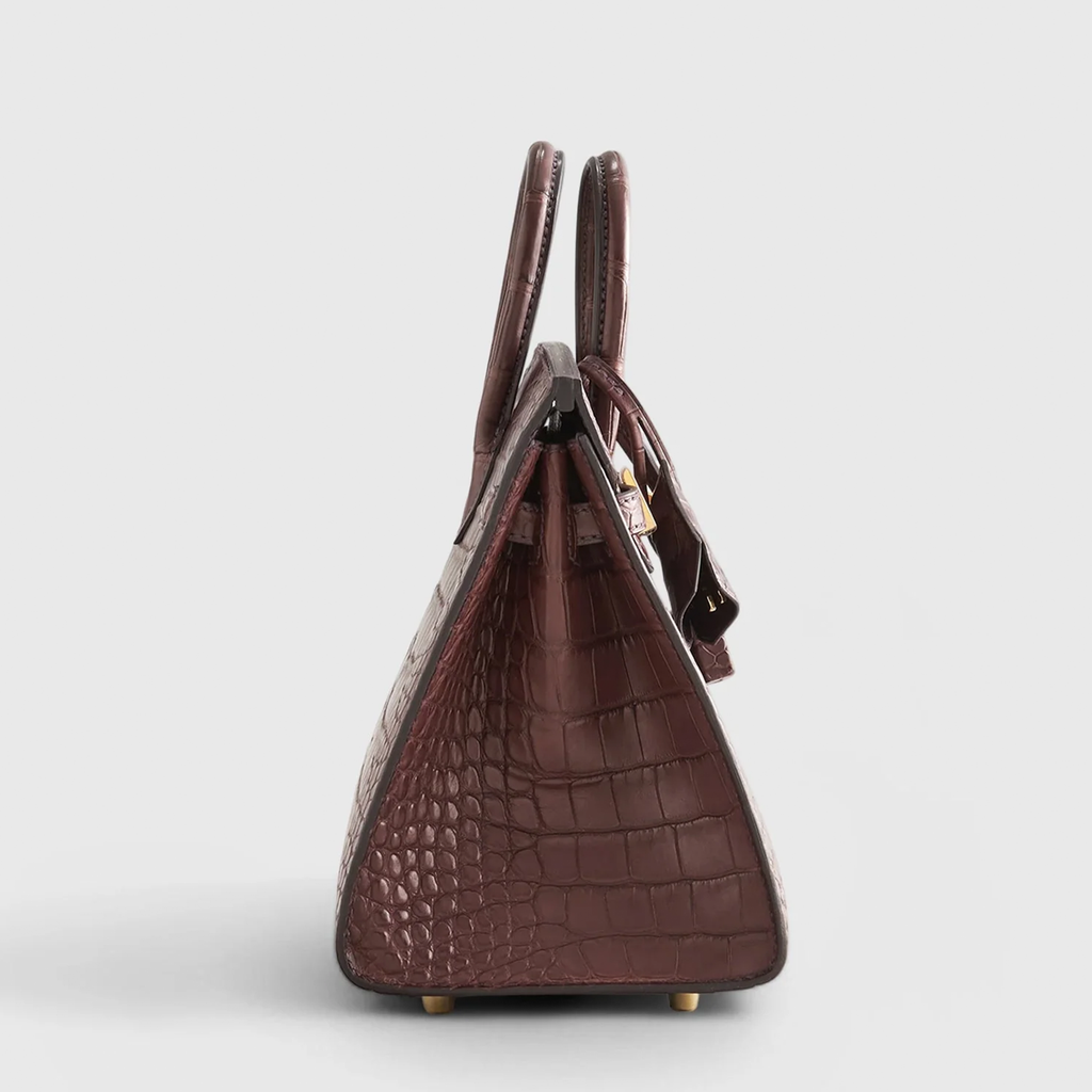Rich Matte Hazelnut Brown Segmented Scaled Compact Sharp Edged Trapezoid Tote With Polished Warm Golden Twist Lock Hardware And Suspended Textured Metal Padlock Charm Crocodile Grain