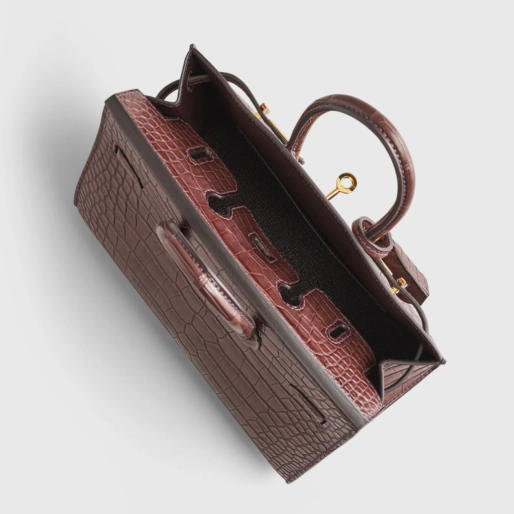 Rich Matte Hazelnut Brown Segmented Scaled Compact Sharp Edged Trapezoid Tote With Polished Warm Golden Twist Lock Hardware And Suspended Textured Metal Padlock Charm Crocodile Grain